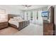 Serene main bedroom with a large bed, soft lighting, and a view of the backyard at 476 Dudley Dr, Fort Mill, SC 29715