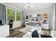 Bright bedroom featuring built-in bookshelves, modern decor, and large windows with nature views at 513 Sandbar Pt, Lake Wylie, SC 29710