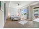 Bright bedroom featuring a tray ceiling, ample natural light, and balcony access at 513 Sandbar Pt, Lake Wylie, SC 29710