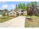 Attractive home with well-kept lawn, stone accents, and a long driveway leading to a two car garage at 513 Sandbar Pt, Lake Wylie, SC 29710