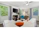Inviting living room featuring a fireplace, hardwood floors, and bright natural light at 513 Sandbar Pt, Lake Wylie, SC 29710