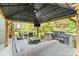 Inviting outdoor space with a gazebo, comfortable seating, a stone grill, and a mounted television at 513 Sandbar Pt, Lake Wylie, SC 29710