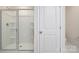 Bright bathroom featuring a glass enclosed shower with built in shelving at 6153 Helens Rest Ln, Lincolnton, NC 28092