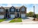Charming townhomes with individual garages, stone accents, and well-manicured lawns create inviting curb appeal at 6153 Helens Rest Ln, Lincolnton, NC 28092