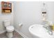 Cozy half bathroom with modern fixtures, wood-look floors, and neutral color scheme at 6153 Helens Rest Ln, Lincolnton, NC 28092