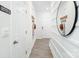 Bright hallway with wood floors, decorative mirror and wall hooks create an organized and stylish entryway at 6153 Helens Rest Ln, Lincolnton, NC 28092