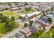 Aerial view of a residential neighborhood with tree-lined streets and nearby community buildings at 6728 Mimosa St, Indian Trail, NC 28079