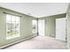 Bedroom featuring green walls, neutral carpeting and lots of natural light through two windows at 6728 Mimosa St, Indian Trail, NC 28079