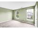 Bedroom featuring green walls, neutral carpeting and lots of natural light through two windows at 6728 Mimosa St, Indian Trail, NC 28079