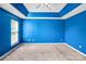 Bright bedroom featuring blue walls, grey carpeting and ample natural light from a large window at 6728 Mimosa St, Indian Trail, NC 28079