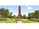 Striking clock tower centerpiece with manicured landscaping and fountain feature at 6728 Mimosa St, Indian Trail, NC 28079
