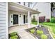 Covered front porch with black door and stylish white pillars at 6728 Mimosa St, Indian Trail, NC 28079