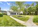 Two-story house with manicured front yard, mature tree, and hardscaped walkways at 6728 Mimosa St, Indian Trail, NC 28079