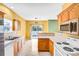 Bright kitchen with wooden cabinets, ample counter space, and an open view to the backyard at 6728 Mimosa St, Indian Trail, NC 28079