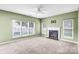 Inviting living room featuring a classic fireplace, large windows, and neutral carpet at 6728 Mimosa St, Indian Trail, NC 28079