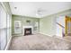 Bright living room showcasing a fireplace, multiple windows, and seamless flow into adjacent spaces at 6728 Mimosa St, Indian Trail, NC 28079