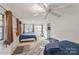 Well-lit bedroom featuring two beds, multiple windows, and a ceiling fan at 6778 Emerald Isle Dr, Sherrills Ford, NC 28673