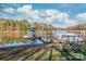 Waterfront property featuring a private dock with boat lift and a scenic lake view on a partly cloudy day at 6778 Emerald Isle Dr, Sherrills Ford, NC 28673
