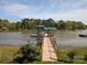 Picturesque wooden dock leading to a covered boathouse, perfect for enjoying waterfront living and recreation at 6778 Emerald Isle Dr, Sherrills Ford, NC 28673