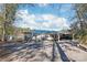 Lakeside home featuring a metal roof, screened porch, and covered parking at 6778 Emerald Isle Dr, Sherrills Ford, NC 28673