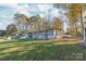 Beautiful home featuring a large screened-in porch and well-maintained lawn at 6778 Emerald Isle Dr, Sherrills Ford, NC 28673