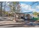 Exterior view showcasing the house, lakeside location, and covered parking at 6778 Emerald Isle Dr, Sherrills Ford, NC 28673