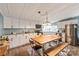 Spacious kitchen featuring ample cabinets, modern appliances, and a large dining table at 6778 Emerald Isle Dr, Sherrills Ford, NC 28673