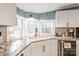 Modern kitchen featuring granite countertops, stainless steel appliances and corner sink at 6778 Emerald Isle Dr, Sherrills Ford, NC 28673