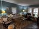 Cozy living room featuring comfortable seating, natural light from windows, and stylish decor with lake accents at 6778 Emerald Isle Dr, Sherrills Ford, NC 28673