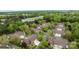 Aerial view of a neighborhood with lush trees, mature landscaping and roadway access at 7502 Hurstbourne Green Dr, Charlotte, NC 28277