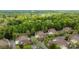 Gorgeous aerial view of quaint brown-roofed homes nestled among mature trees in a charming neighborhood at 7502 Hurstbourne Green Dr, Charlotte, NC 28277