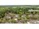 Aerial view of a neighborhood with lush trees, mature landscaping and roadway access at 7502 Hurstbourne Green Dr, Charlotte, NC 28277