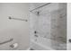Beautiful bathroom featuring a tub with tiled walls and modern fixtures at 7502 Hurstbourne Green Dr, Charlotte, NC 28277
