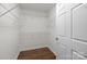 Walk-in closet with white wire shelving and hardwood floors at 7502 Hurstbourne Green Dr, Charlotte, NC 28277