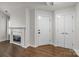Entryway featuring a fireplace, coat closet, and beautiful hardwood floors at 7502 Hurstbourne Green Dr, Charlotte, NC 28277