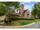 Classic brick home featuring lush landscaping, a prominent chimney, and well-maintained lawn at 7502 Hurstbourne Green Dr, Charlotte, NC 28277