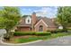 Beautiful brick home features mature landscaping, a prominent chimney, and well-manicured lawn at 7502 Hurstbourne Green Dr, Charlotte, NC 28277