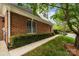 Brick exterior with manicured landscaping and a sidewalk leading to the home at 7502 Hurstbourne Green Dr, Charlotte, NC 28277