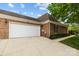 Exterior of the home featuring a white garage door and brick facade at 7502 Hurstbourne Green Dr, Charlotte, NC 28277