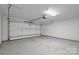 Interior of the garage showcasing an epoxy floor and ample space at 7502 Hurstbourne Green Dr, Charlotte, NC 28277