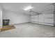 Spacious garage featuring an epoxy floor and an entrance ramp at 7502 Hurstbourne Green Dr, Charlotte, NC 28277