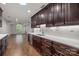 Bright kitchen featuring dark cabinetry, stainless steel appliances, and a white subway tile backsplash at 7502 Hurstbourne Green Dr, Charlotte, NC 28277