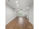 Open-concept living room featuring vaulted ceiling, fan, hardwood floors and natural light at 7502 Hurstbourne Green Dr, Charlotte, NC 28277