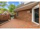 Quaint brick patio with gate access, framed by brick walls and the home's exterior at 7502 Hurstbourne Green Dr, Charlotte, NC 28277