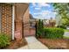 Charming brick patio featuring an iron gate entrance and surrounded by manicured landscaping at 7502 Hurstbourne Green Dr, Charlotte, NC 28277