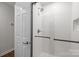 Modern all-white shower with glass door and tiled walls at 7502 Hurstbourne Green Dr, Charlotte, NC 28277