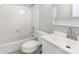 Bright, clean bathroom featuring a white vanity, toilet, and tiled tub/shower combination at 7507 Holly Grove Ct, Charlotte, NC 28227