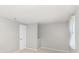 This cozy bedroom has neutral carpet, a paneled door, and natural light from a window at 7507 Holly Grove Ct, Charlotte, NC 28227