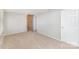 Bright bedroom featuring tan carpet, a brick column, and a white paneled door at 7507 Holly Grove Ct, Charlotte, NC 28227