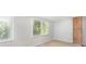 A cozy bedroom has neutral carpet and two large windows allowing plenty of natural light at 7507 Holly Grove Ct, Charlotte, NC 28227